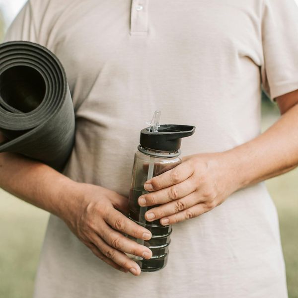 Close-up of yoga mat and water bottle in a calm setting.